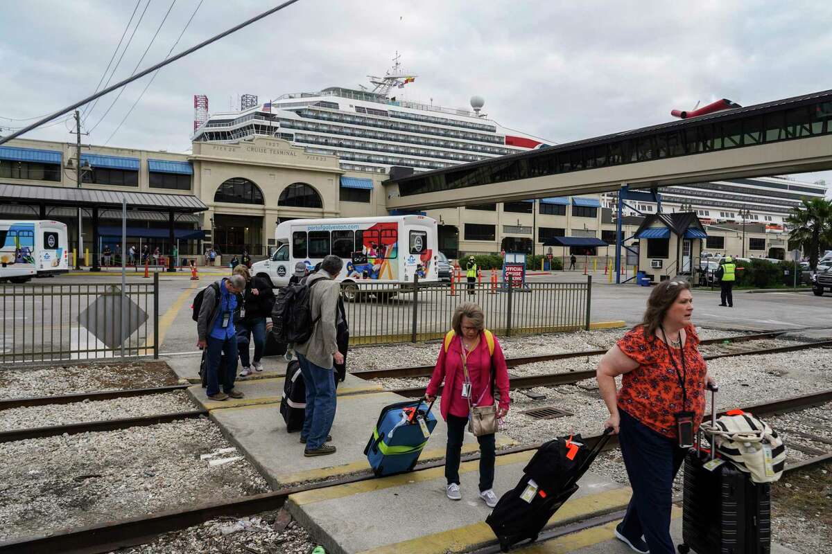Passengers of Carnival Cruise Line walk out of Port of Galveston Cruise Terminal on Sunday March 8, 2020 in Galveston, Texas. The cruise ship was rerouted over worries it wouldn’t be able to dock in some Caribbean ports because many destinations are tightening entry policies amid growing global concern over the COVID-19 outbreak.