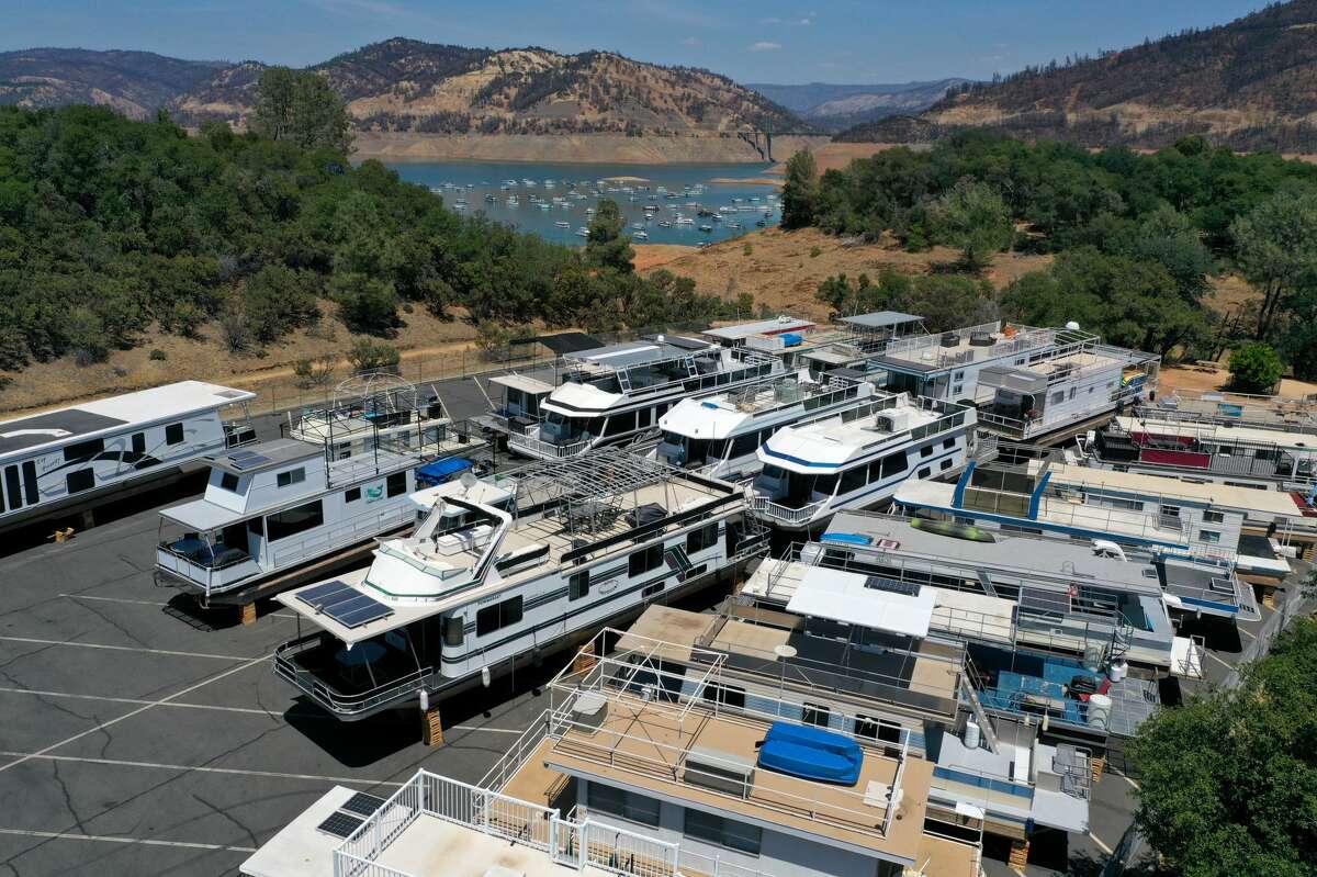 In an aerial view, houseboats sit in the Bidwell Canyon Marina parking lot at Lake Oroville on June 1, 2021, in Oroville, Calif. As water levels continue to fall at Lake Oroville, officials are flagging houseboats that are anchored on the lake for removal to avoid being stuck or damaged. Lake Oroville is currently at 38% of normal capacity. According to the U.S. Drought Monitor, 16% of California is in exceptional drought, the most severe level of dryness. 