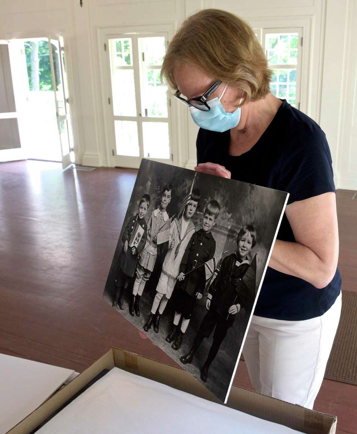 Hildegard Grob, executive director of the Keeler Tavern Museum, holds a print the museum had made from a Joseph Hartmann glass plate (negative on glass) that is part of their collection.