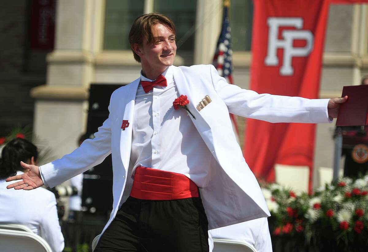 Graduate Philip Gallagher shows off his cumberbun after receiving his diploma at the Fairfield Prep graduation in Fairfield on Sunday.