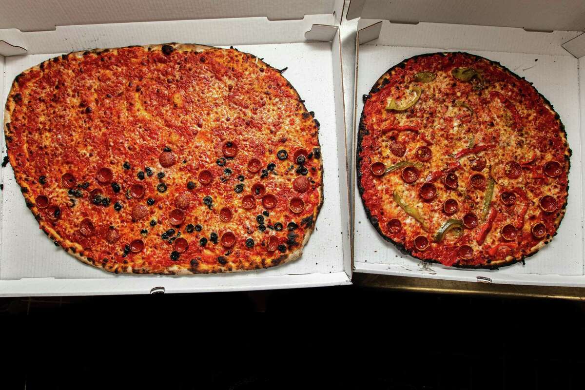 A large and medium-size pizza at Sally's Apizza in New Haven.