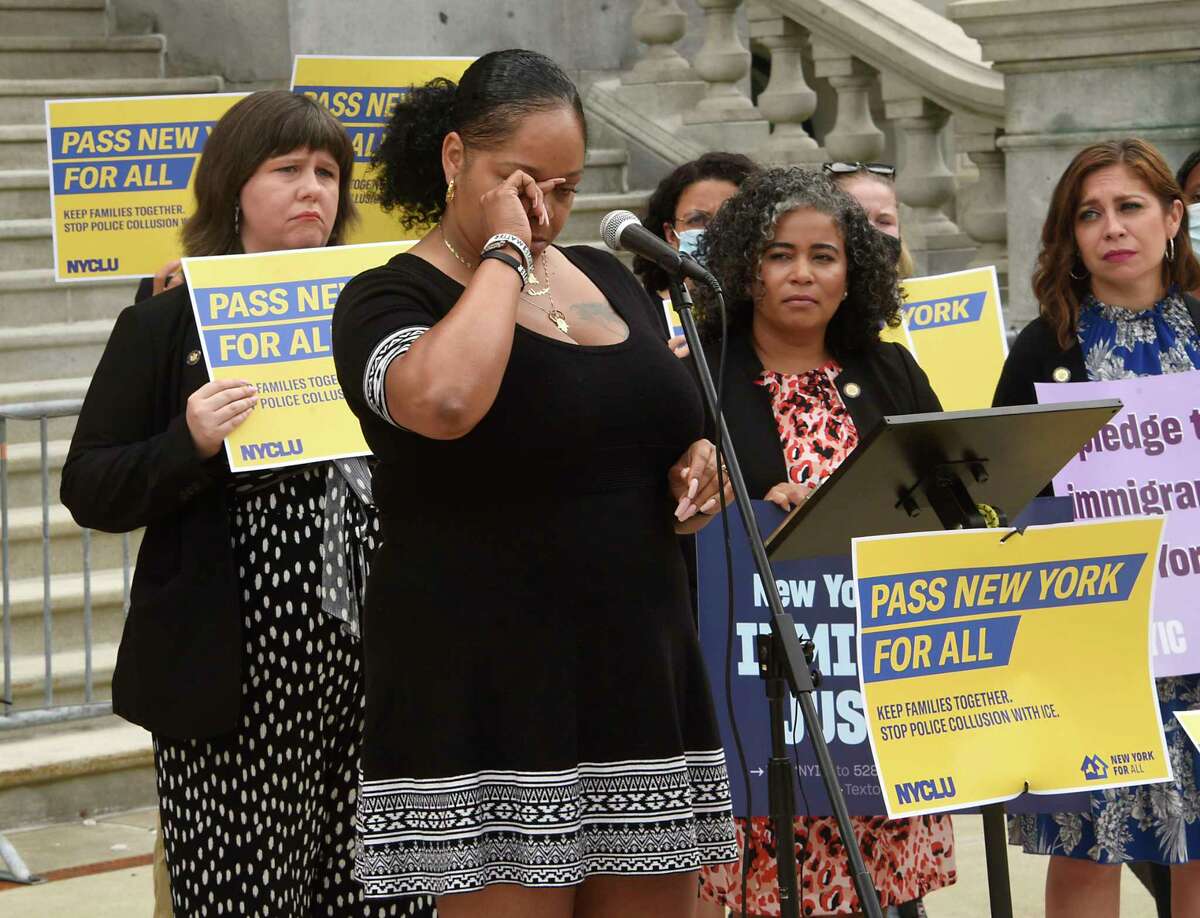 Columbia County Sanctuary Movement member Dalila Yeend wipes tears from her eyes while she speaks on Tuesday, June 8, 2021 in Albany, N.Y. CCSM is one of the immigration advocacy groups calling on the state legislature and Gov. Kathy Hochul to expand the Excluded Workers Funds. (Lori Van Buren/Times Union)