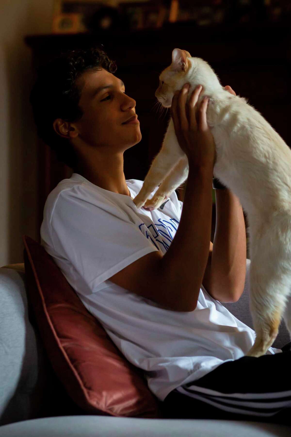 Sixteen-year-old Jean Paul “JP” Durand holds his cat, Don Juan, in his home in Houston on Monday, May 10, 2021. Durand encourages other teens to take charge of their health as a TeenWell ambassador for Legacy Community Health.