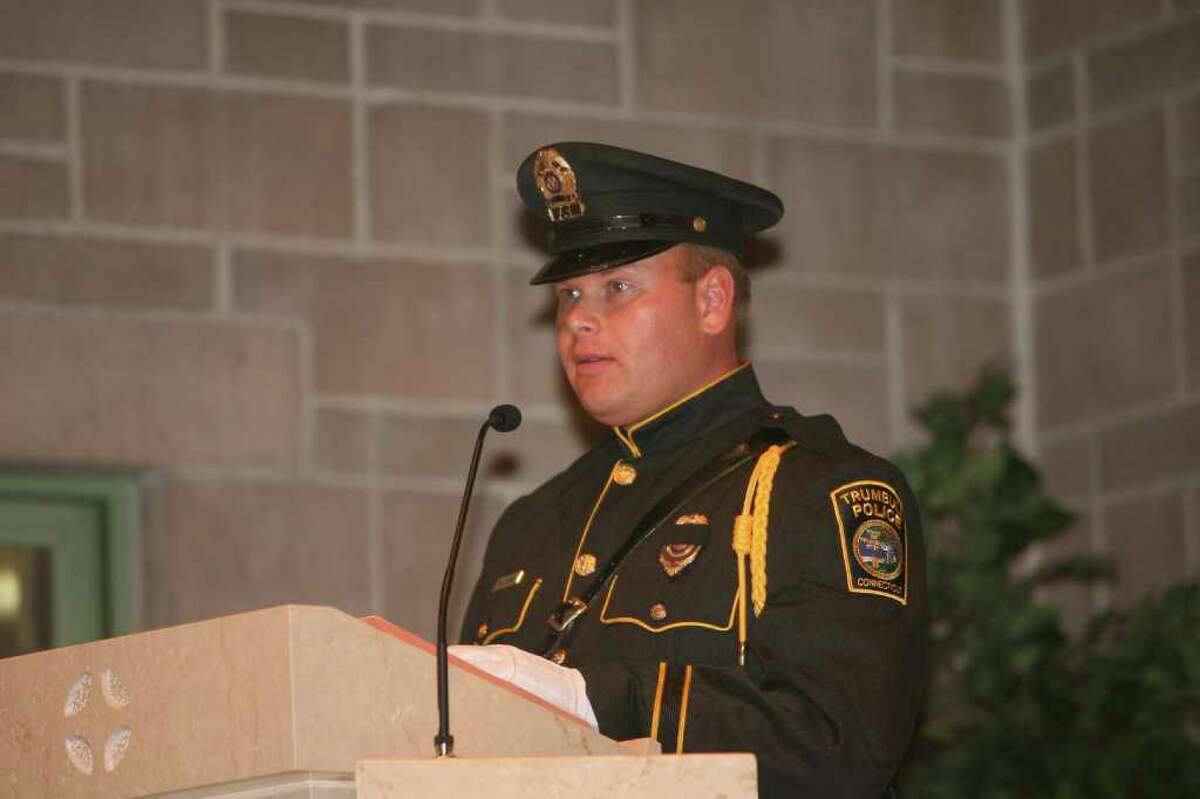 Trumbull Police officer Tim Fedor reads during mass at Saint Catherine of Siena in Trumbull. The Diocese of Bridgeport commemorated the ninth anniversary of 9/11 by honoring law enforcement, fire and emergency service personnel in a Blue Mass on Sunday, September, 12, 2010.