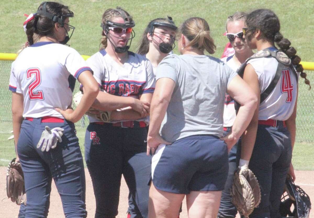 Big Rapids softball coach Dawn Thompson talks with her pitcher Rylie Haist (center) and her infielders during the district tournament last weekend. (Pioneer photo/John Raffel)