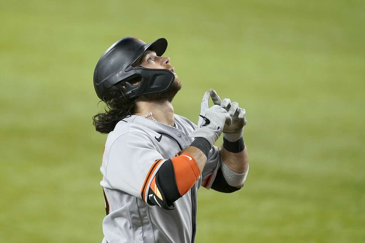 San Francisco Giants' Brandon Crawford gestures skyward as he approaches the plate after hitting a three-run home run on a pitch from Texas Rangers relief pitcher Taylor Hearn in the ninth inning of a baseball game in Arlington, Texas, Tuesday, June 8, 2021. (AP Photo/Tony Gutierrez)