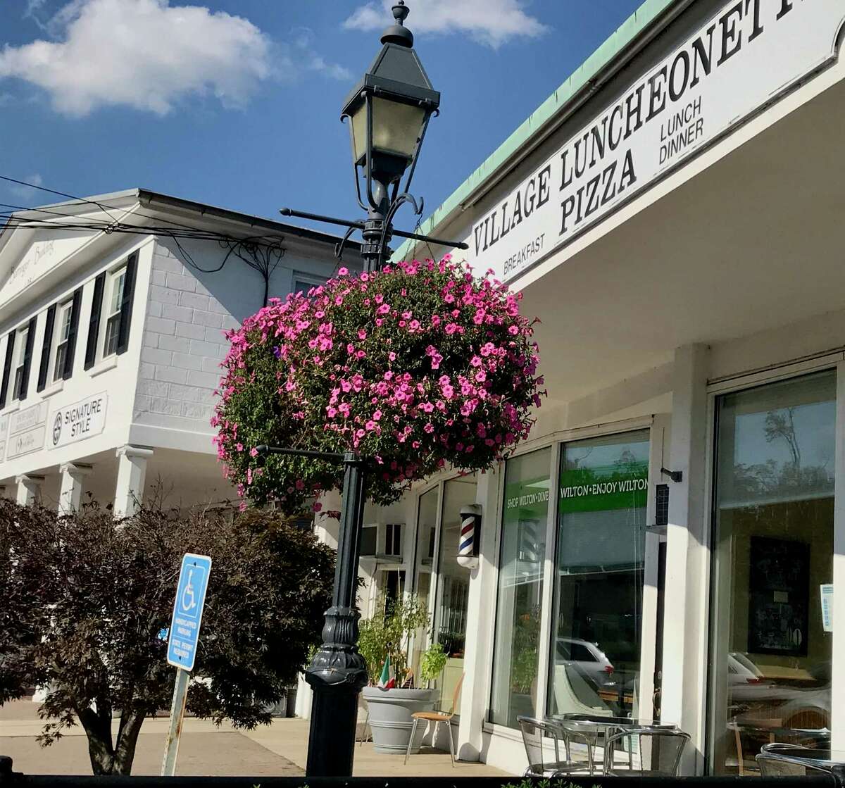 Wilton's hanging flower baskets, a harbinger of the summer, are once again adorning the town's lampposts, such as this flower basket at Village Luncheonette & Pizza located at 88 Old Ridgefield Road.