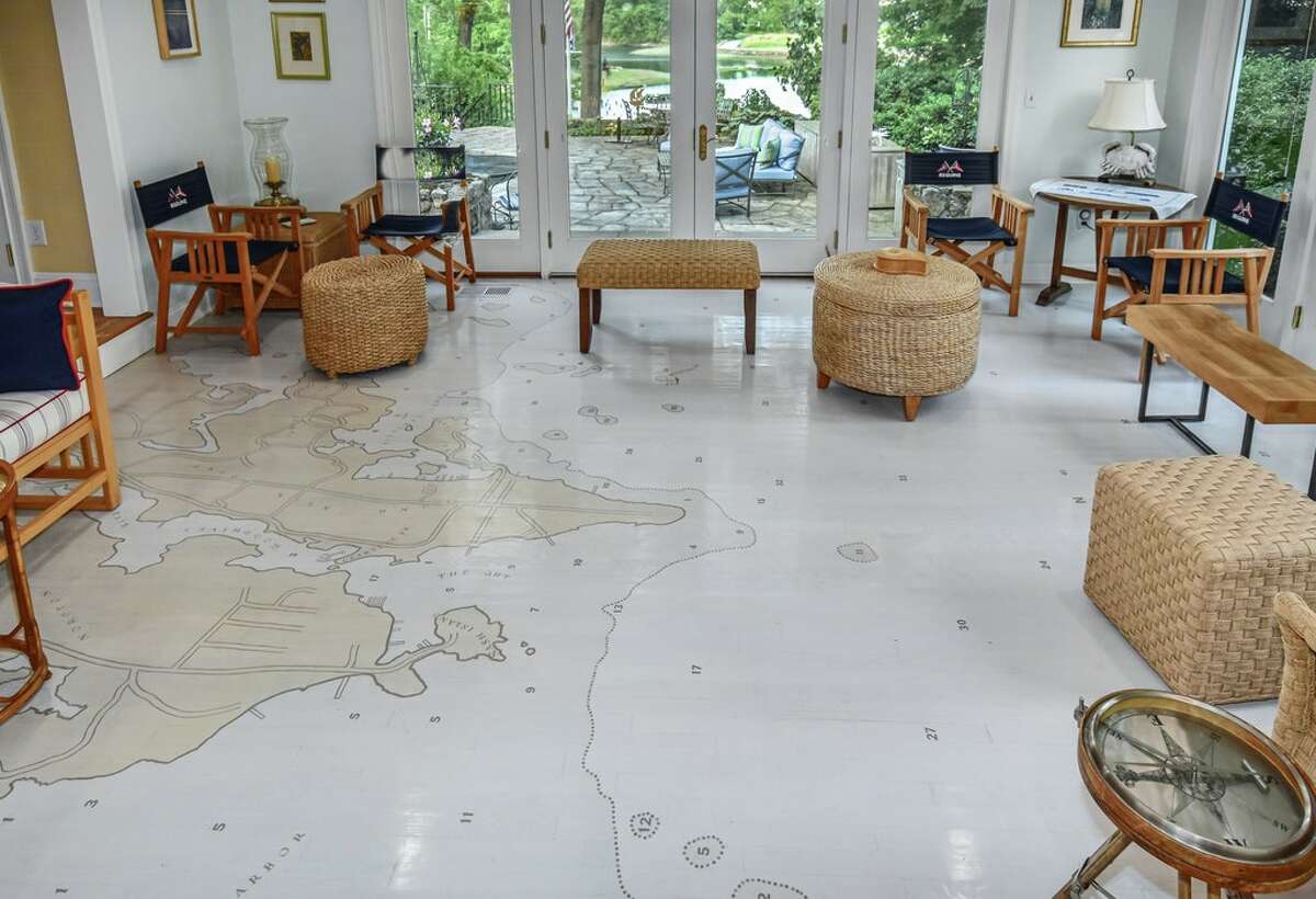 The home on 123 Long Neck Point Road in Darien, Conn. has a hand-painted map on the floor of the sunroom; it is one of a few murals painted throughout the home. 