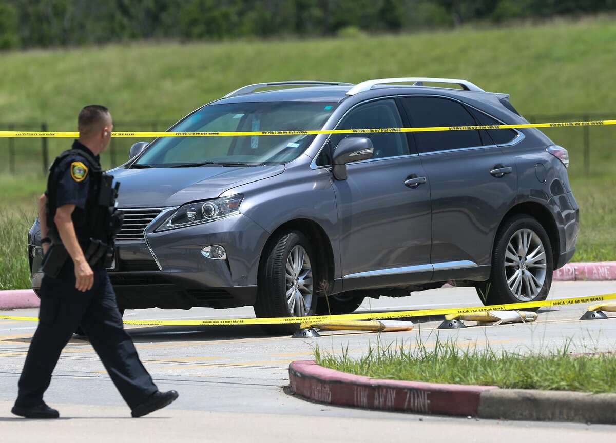 A vehicle sits at the scene of a shooting being investigated by police at the north entrance of North Forest High School, Wednesday, June 9, 2021, in Houston.