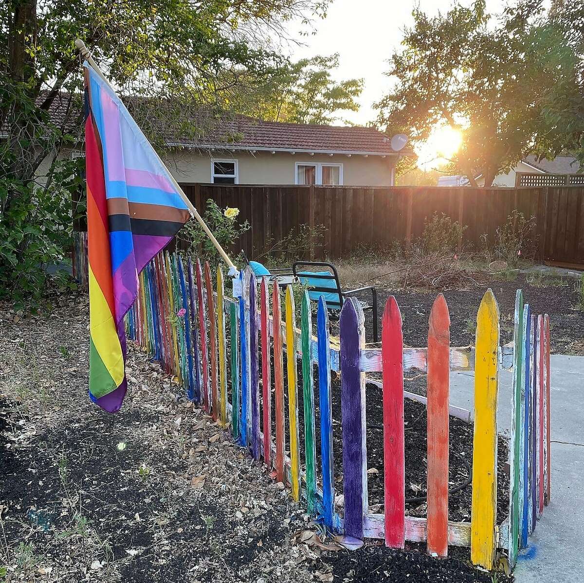 The fence outsdie Christine Horley’s home in Walnut Creek. After her Pride flags were stolen — twice — Horley’s daughter enlisted the help of her friends to paint the fence the color of the rainbow Pride flag.