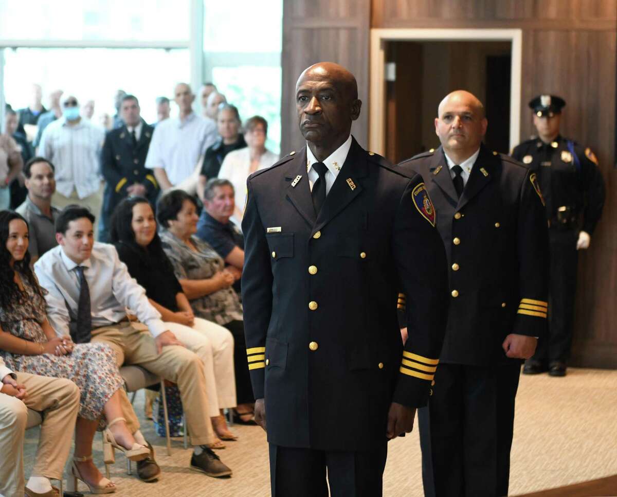 Officers Silas Redd, left, and Louis DeRubeis stand at attention during the ceremony promoting them to Assistant Police Chiefs at the Stamford Police Department in Stamford, Conn. Tuesday, June 8, 2021.