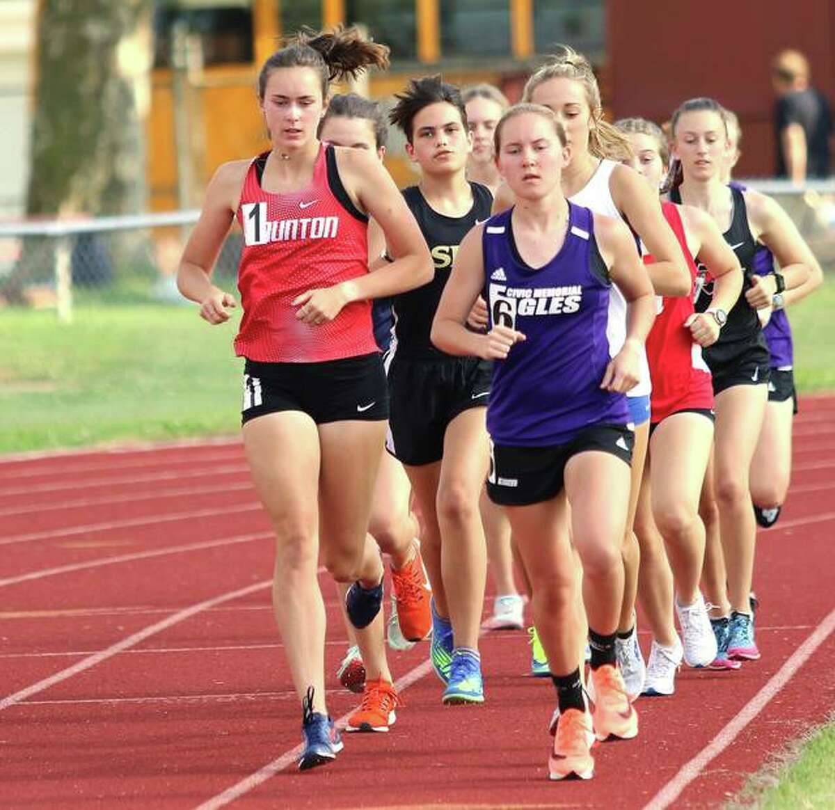 Staunton’s Lydia Roller (left) and CM’s Hannah Meiser (right) run on the lead in the opening lap of the 3,200 meters on Friday at the EA-WR Class 2A Sectional in Wood River.