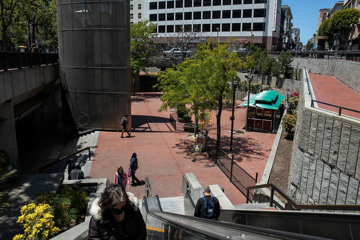 People walk through Hallidie Plaza near the Powell Street cable car turnaround at Market Street in San Francisco, Calif. Tuesday, June 8, 2021. Hallidie Plaza is slated to be the focus of yet another city upgrade effort, at least the fourth in 20 years.