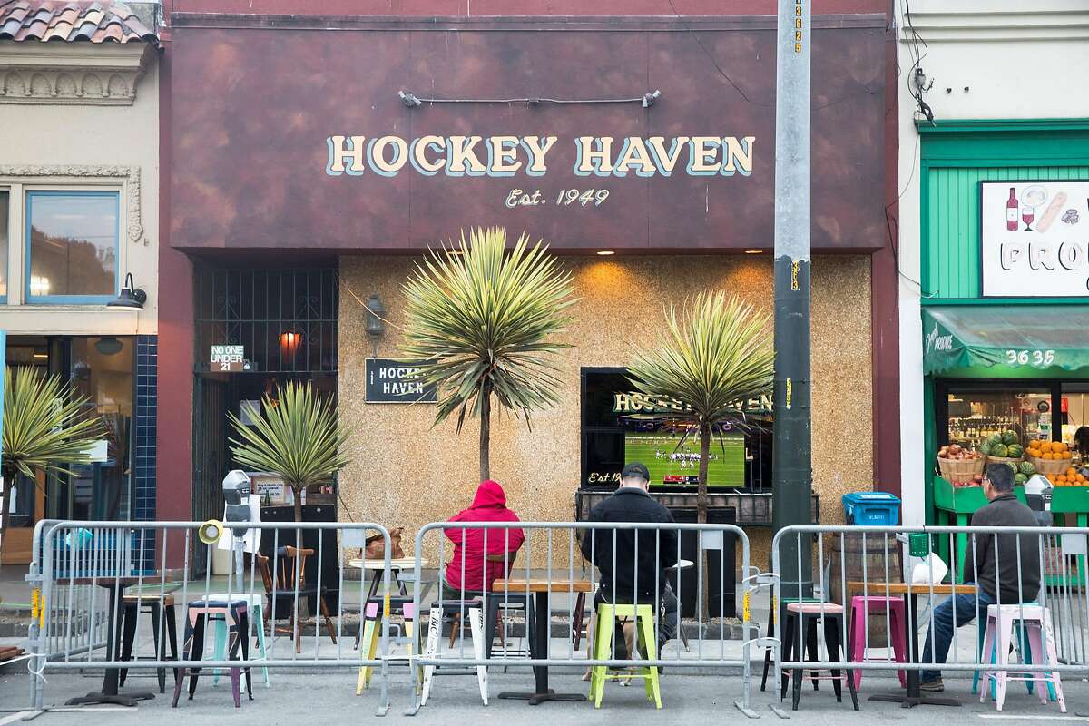 Patrons dine and have drinks outside Hockey Haven in their outdoor seating in San Francisco on Oct. 8, 2020.