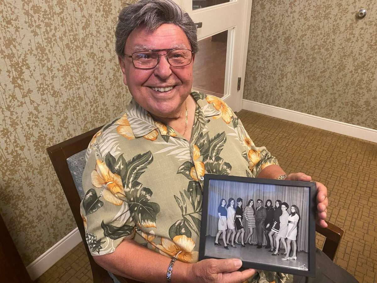 Don Scinto shows off a photo from his days performing at the Polka Dot Playhouse in his hometown of Bridgeport.