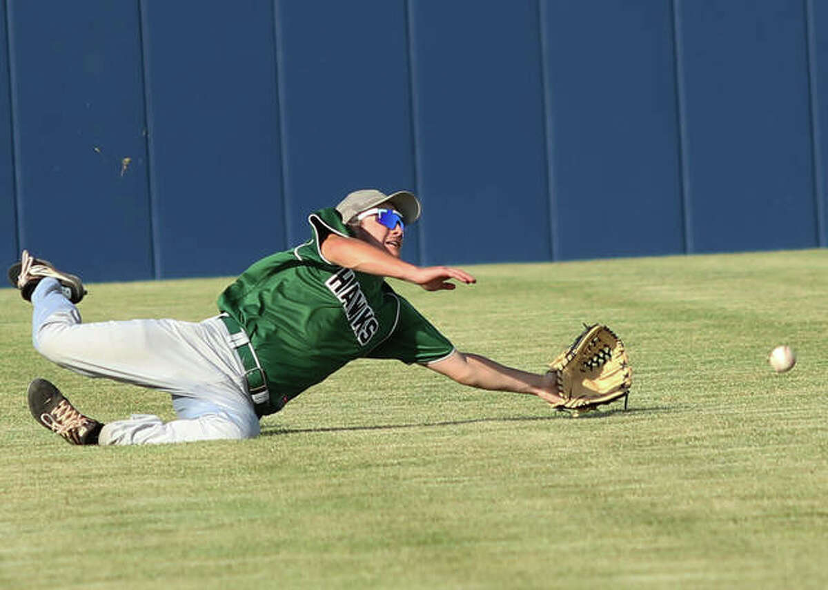 Carrollton center fielder Jackson Cotner dives but can’t get to a ball that goes for a Father McGivney double in the fifth inning of a Class 1A sectional semifinal Wednesday in Glen Carbon.