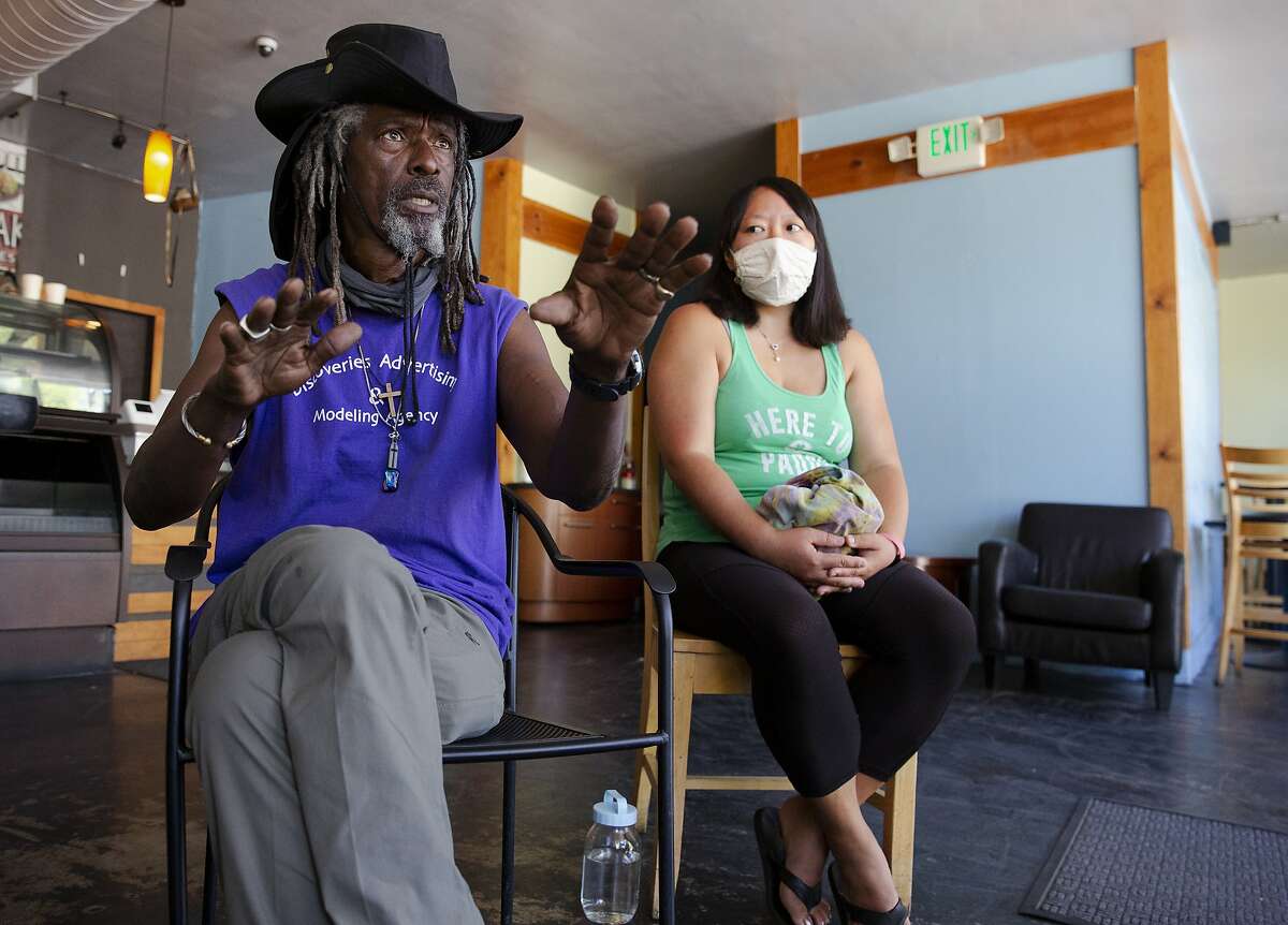 Homeless community activist Nino Parker and Oakland resident Nancy Chang participate in a meeting addressing homelessness at Cafe Lakeview.