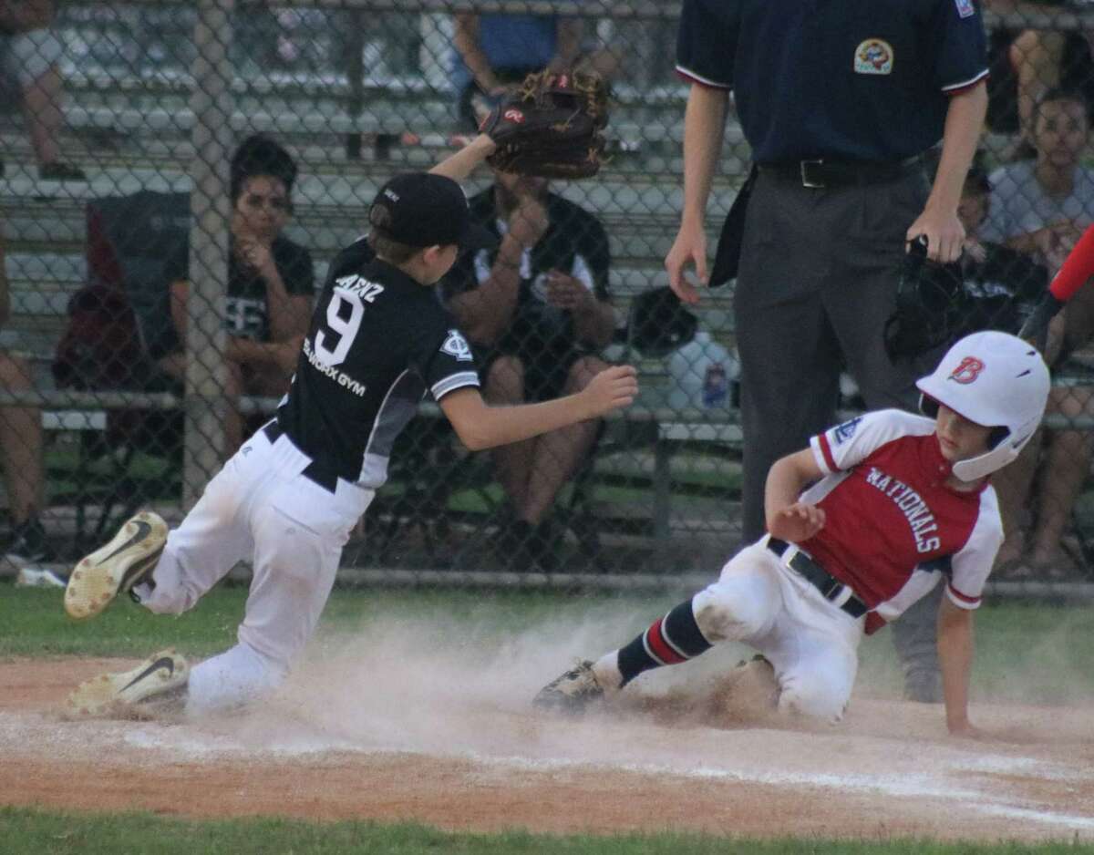 Nationals  player Owen Mann takes advantage of a wild pitch to score the team's first run Wednesday night. Owen, who played both catcher and shortstop on defense, now prepares for tonight's city championship at 5:45.