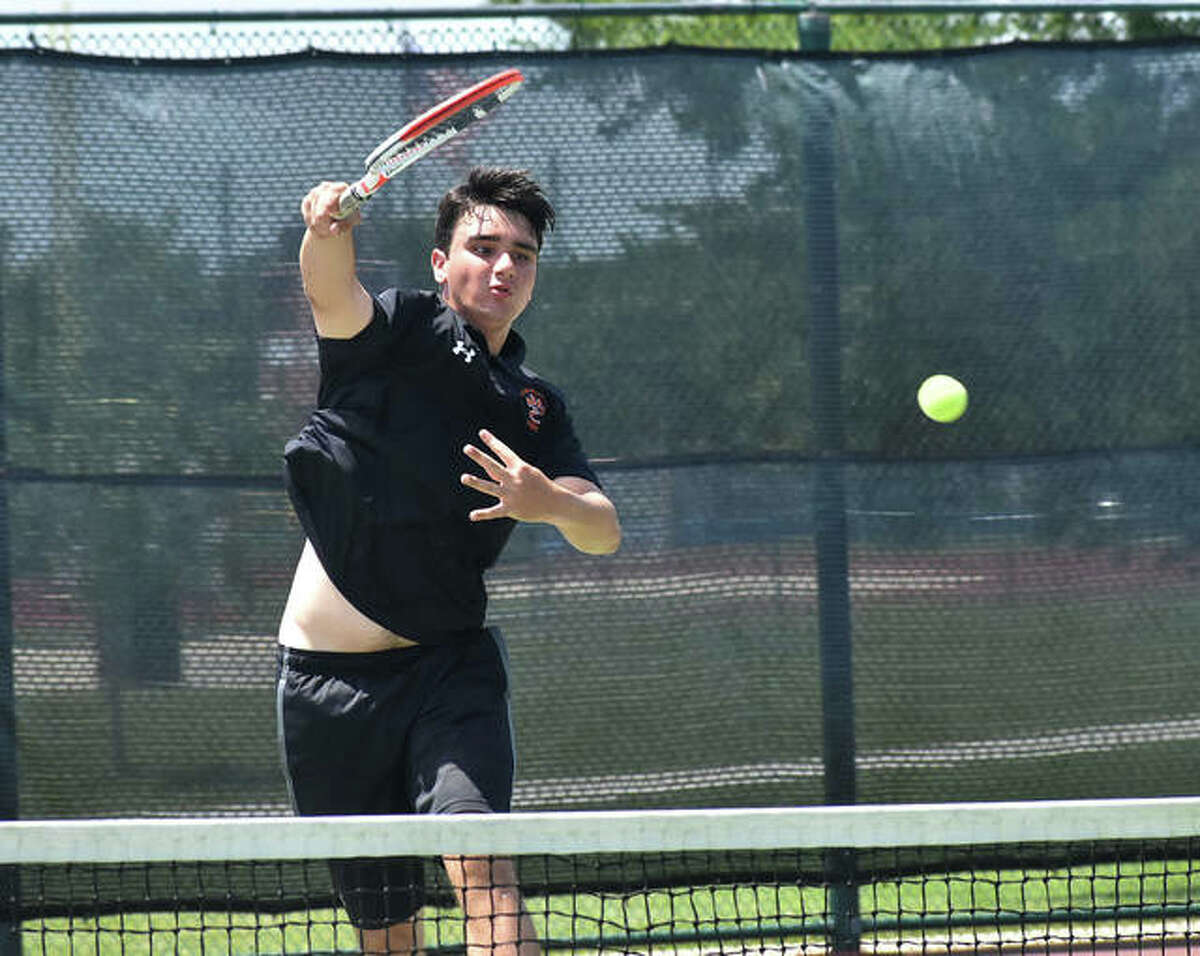 Edwardsville’s Michael Karibian slams down a shot during his doubles match in the Class 2A Belleville West Sectional final on Saturday in Belleville.