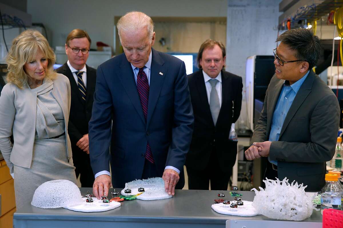 Dr. Wendell Lim, right, at the UCSF Mission Bay campus in San Francisco on Feb. 27, 2016, with then-Vice President Joe Biden, center, and his wife, Jill Biden. Lim, a professor and chair of the university’s cellular and molecular pharmacology department, is leading studies into cell therapies.