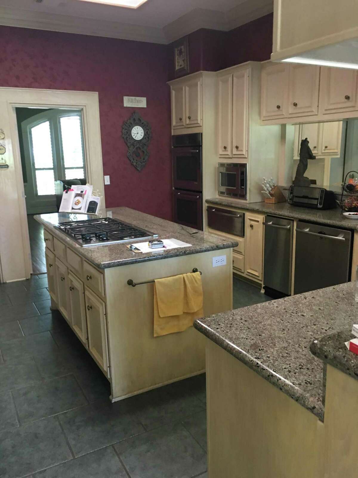 Before: The kitchen had a smaller island and wrap-around peninsula that separated the kitchen from the rest of the main living area.