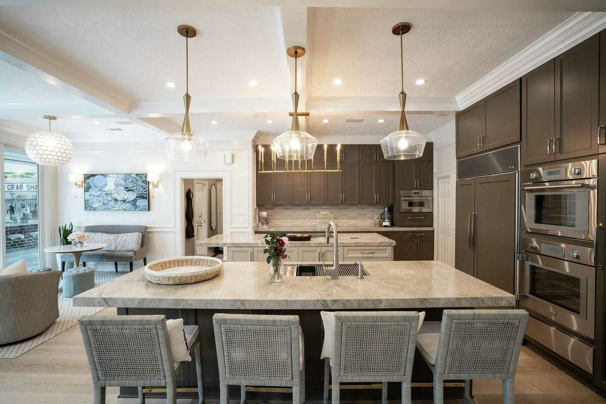 After: The kitchen has a new transitional look, and a double island floor plan replaced the choppy peninsula/pass through.