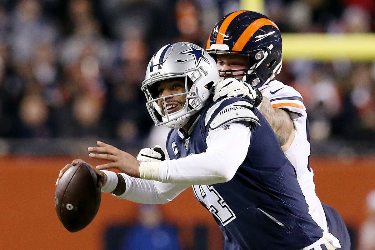 CHICAGO, ILLINOIS - DECEMBER 05: Dak Prescott #4 of the Dallas Cowboys scrambles while being pressured by Brent Urban #92 of the Chicago Bears in the third quarter at Soldier Field on December 05, 2019 in Chicago, Illinois. (Photo by Dylan Buell/Getty Images)