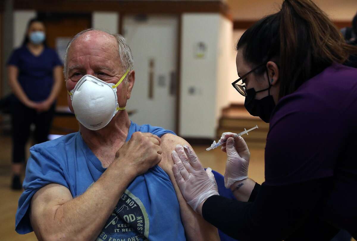 Rad Sommer, 74, of Sebastapol, receives a COVID-19 Pfizer vaccine from Shannon S., LVN with Logistics Health Incorporated/OptumServe, during a COVID-19 vaccination clinic for seniors at the Rohnert Park Community Center on Jan. 27, 2021 in Rohnert Park.