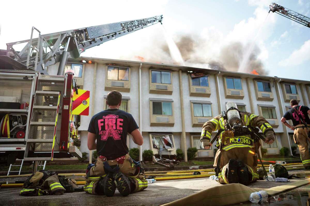 Firefighters from Spring, Ponderosa, Little York, Klein, and The Woodlands Fire Departments battle a multi-alarm fire at the Motel 6 on Cypresswood CT in North Harris County Wednesday, Oct 9, 2019, in Houston.
