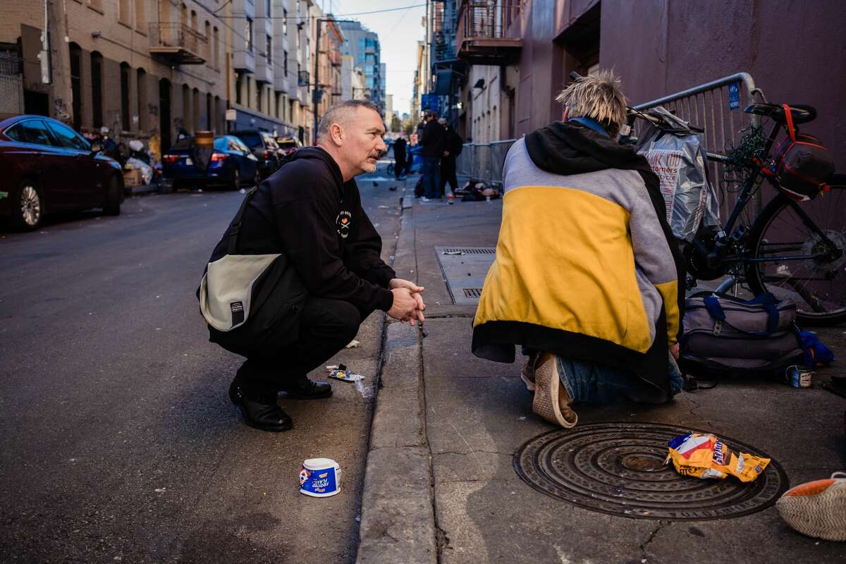 Paul Harkin, director of harm reduction at GLIDE speaks with people on a popular alley way with drug users in the Tenderloin neighborhood to handout narcan, fentanyl detection packets and tinfoil to those drug users in need as a part of outreach on the streets of San Francisco, Calif. on Feb. 3 2020.