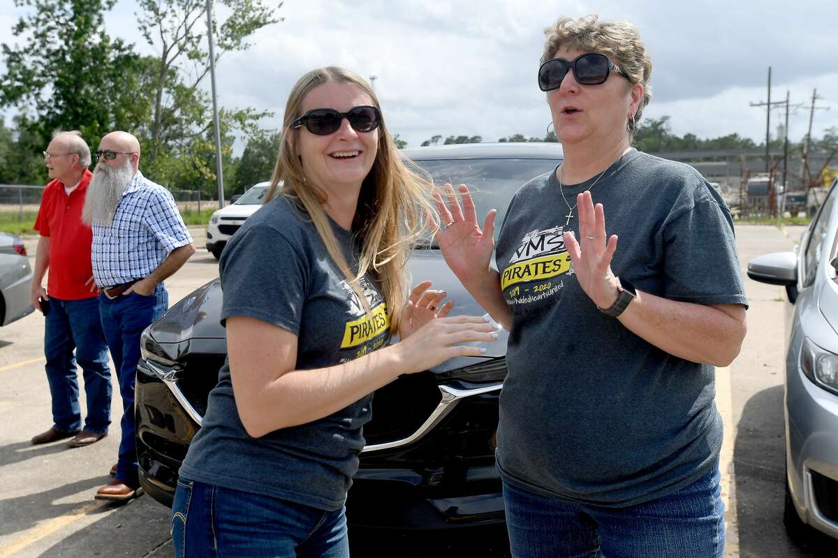 Sixth grade teachers Staci Glach (left) and Martha Scott marvel at the bare ground where their school once stood and reminisce about the spots they remembered as they gather for a groundbreaking ceremony on the long-awaited new Vidor Middle School Thursday. Students and teachers have been working out of portables since the school flooded during Harvey in 2017. Photo made Thursday, June 10, 2021 Kim Brent/The Enterprise