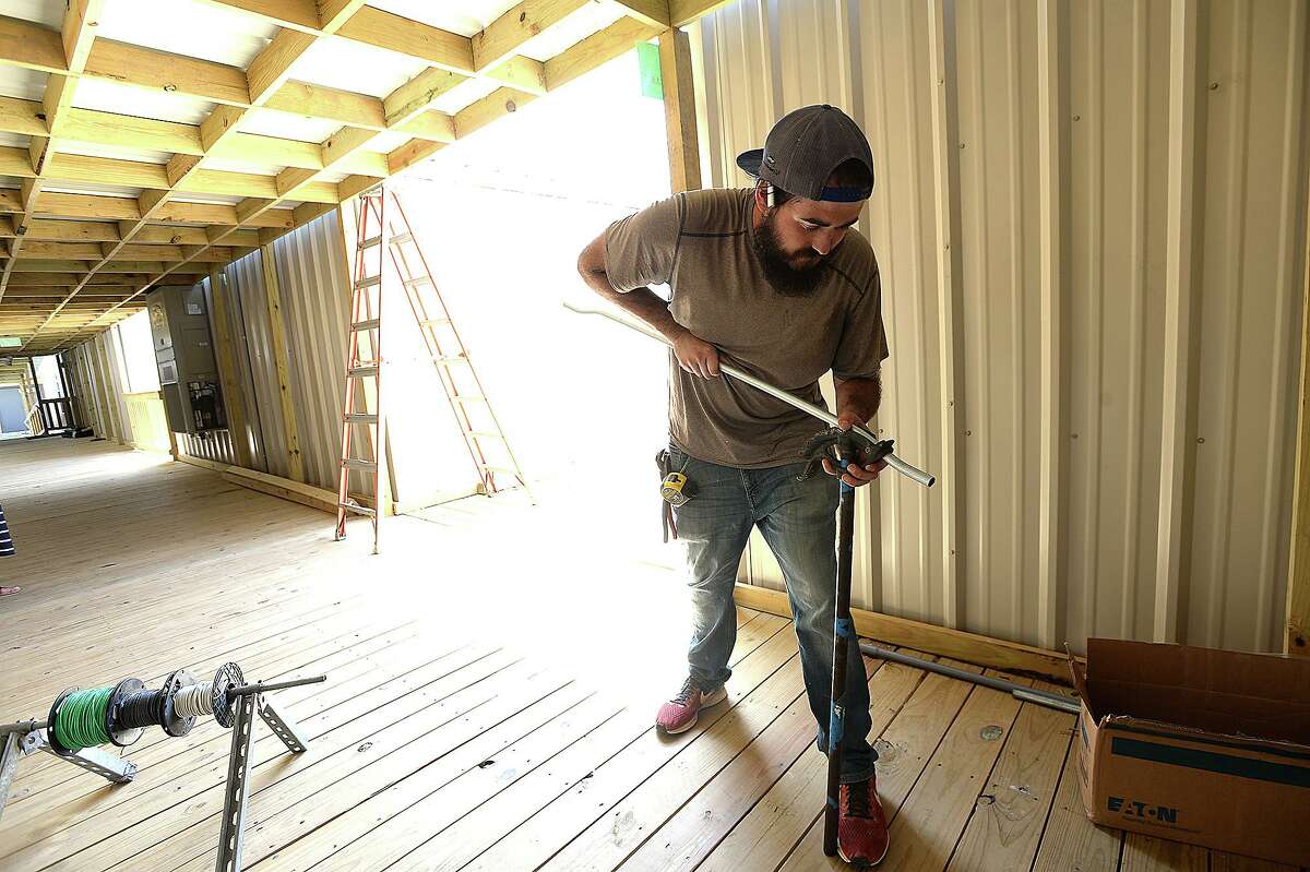 Todd Dixon with Knost Electric bends a piece of pipe as construction continues at the new portables which will serve Vidor Middle School sixth graders and staff at the Vidor Junior High School campus. Fifth graders will be in portables at the high school. The middle school was one of two campuses Vidor ISD lost in Harvey's flooding, and the district is still awaiting word from FEMA on how much they will receive to remodel or build anew. The 10 portable units started arriving in June, and construction crews have been putting them together within the last two weeks, doing the plumbing and electrical work and building covered walkways connecting the units. Last year, the district shuffled its two closed campuses among other school buildings, sharing rooms and other facilities in the wake of Harvey's flooding. This year, sixth graders will be at the portables, which they anticipate will be the case for at least 2 years. Monday, August 20, 2018 Kim Brent/The Enterprise