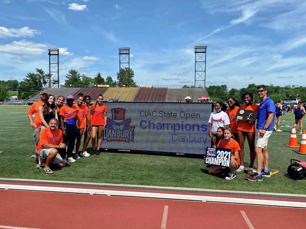 Danbury celebrates winning Girls Track and Field State Open championship on Thursday at Willow Brook Park in New Britain.