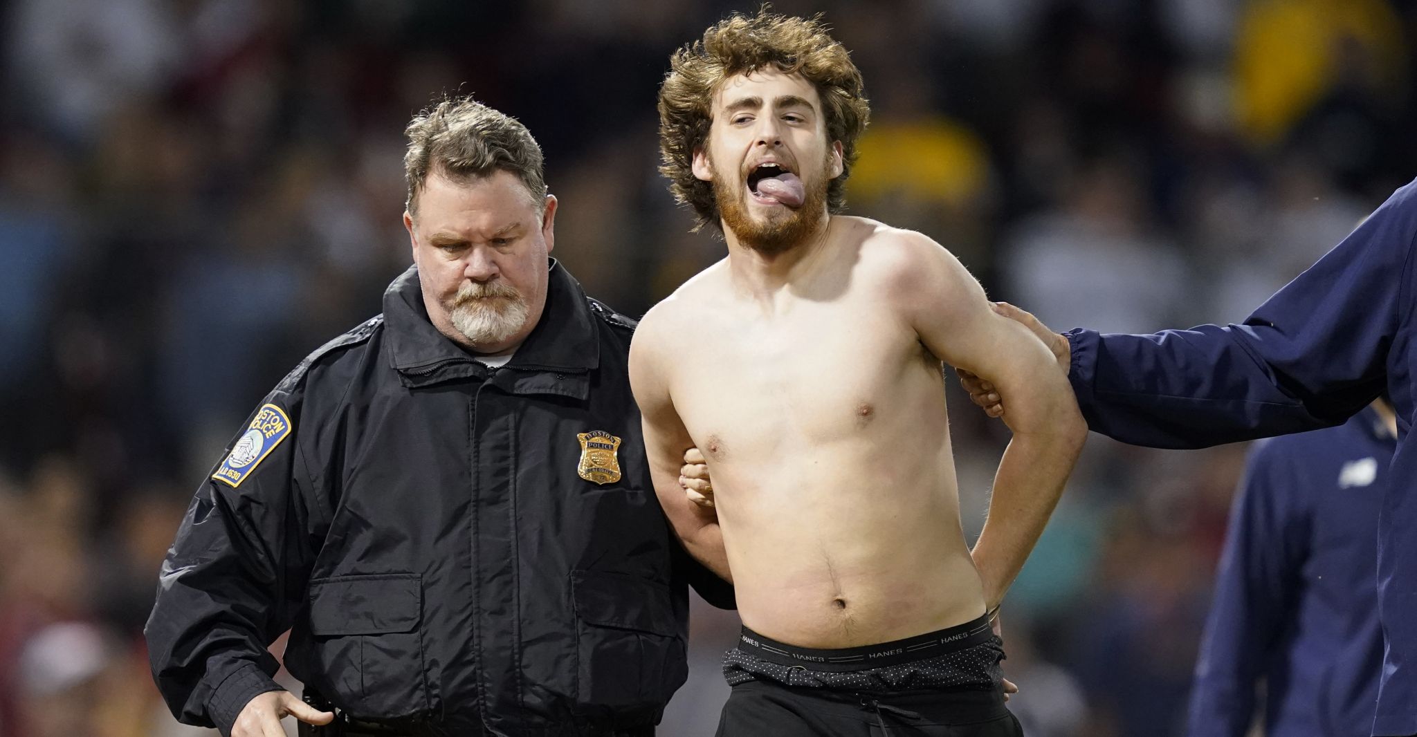 Red Sox fans go shirtless during lengthy rain delay at Fenway