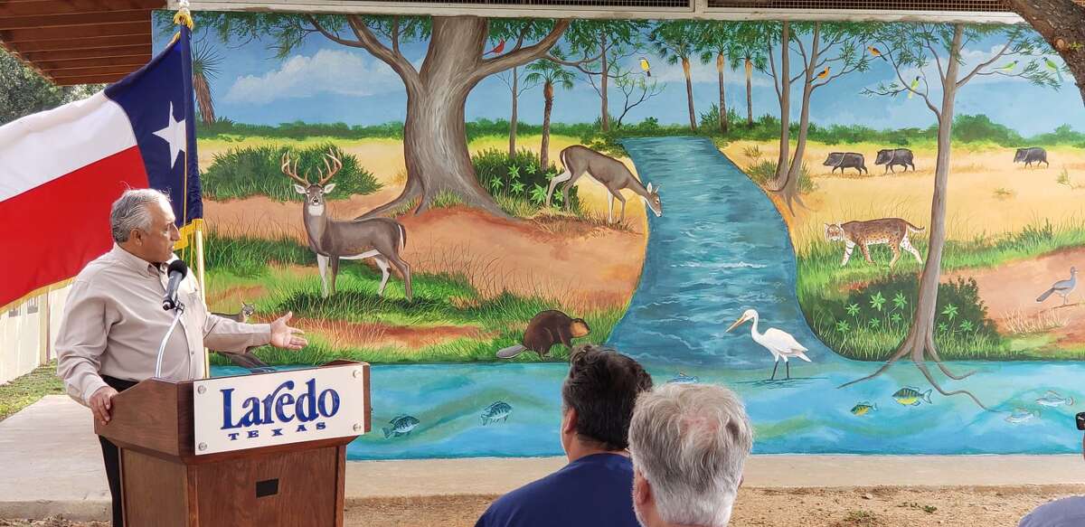 Artist Francisco “Pancho” Farias shows off the “Manadas Creek: the Lifeblood of North Central Park” art mural on Thursday.