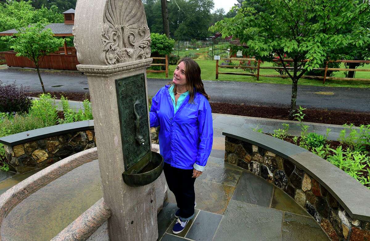 Local historian and DAR member Lisa Grant and the restored Nathan Hale memorial fountain Thursday, June 3, 2021, at Fodor Farm in Norwalk, Conn. Lisa Grant spearheaded the refurbishment of the Nathan Hale fountain which was originally dedicated in 1901 and will be rededicated Sunday.