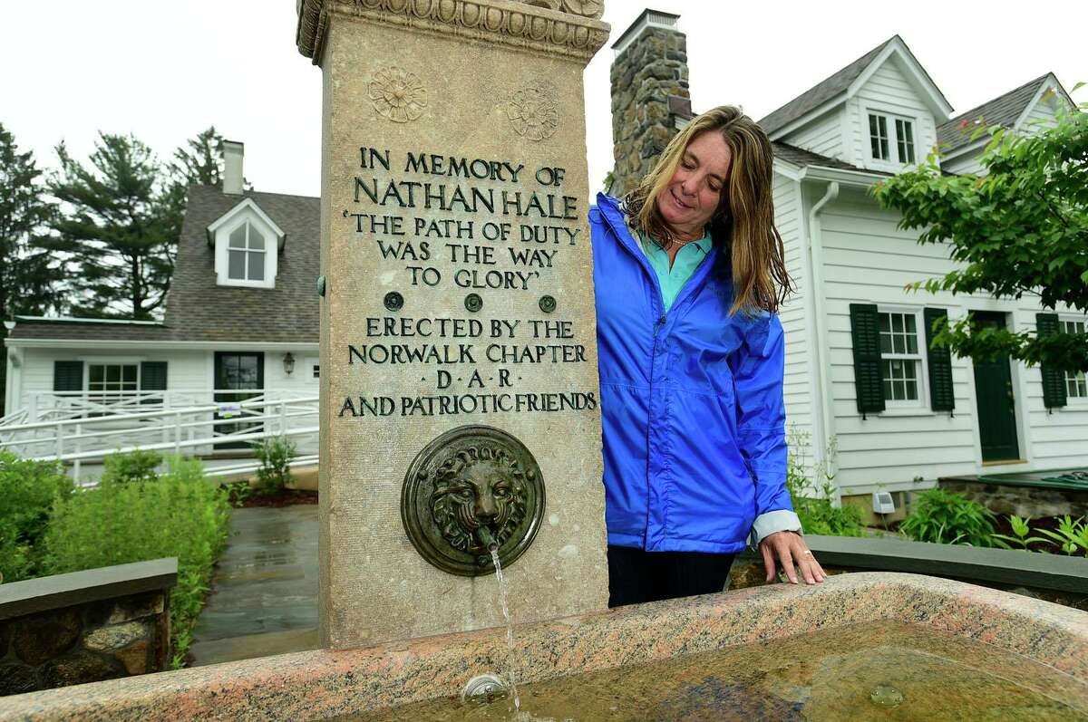Local historian and DAR member Lisa Grant and the restored Nathan Hale memorial fountain Thursday, June 3, 2021, at Fodor Farm in Norwalk, Conn. Lisa Grant spearheaded the refurbishment of the Nathan Hale fountain which was originally dedicated in 1901 and rededicated June 6.