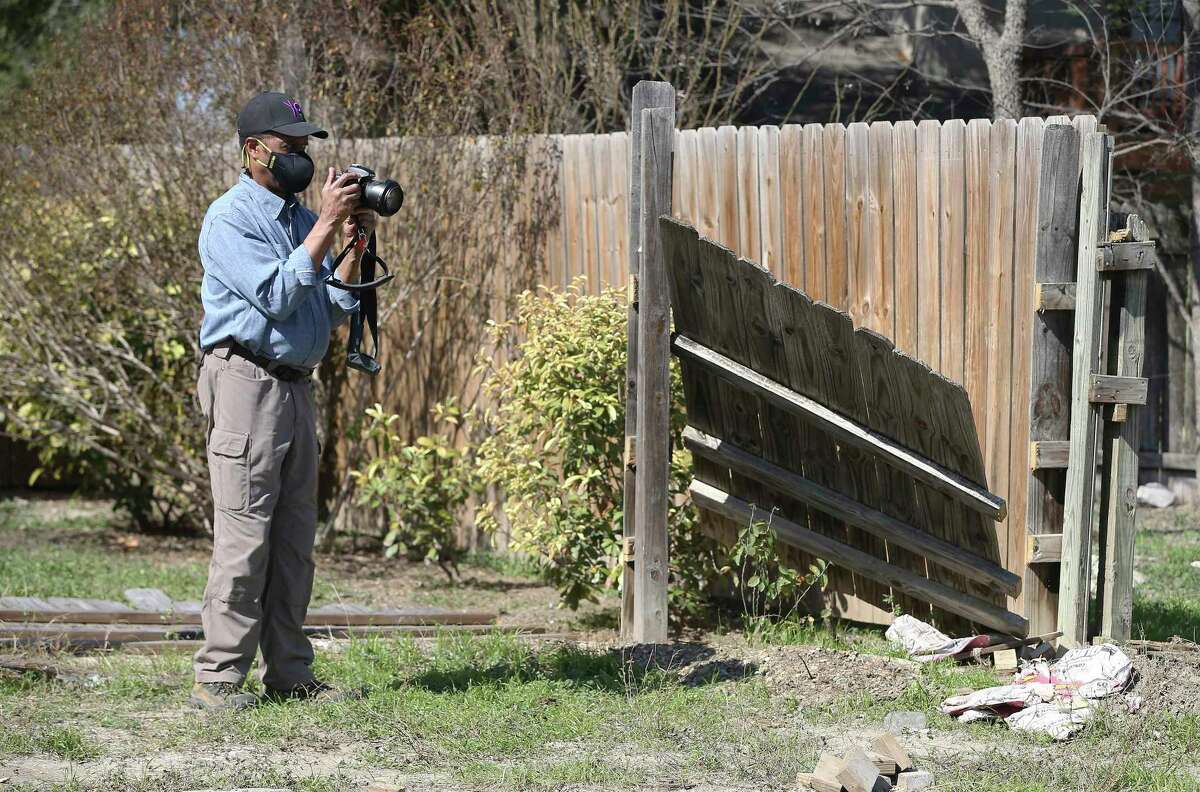 Landscape architect and historian Everett Fly documents the removal of fencing on the grounds of the Hockley Cemetery. Contractors moved the fences of residents whose property overlapped to the cemetery that Fly discovered in a Northeast Side neighborhood on Thursday, Feb. 4, 2021.