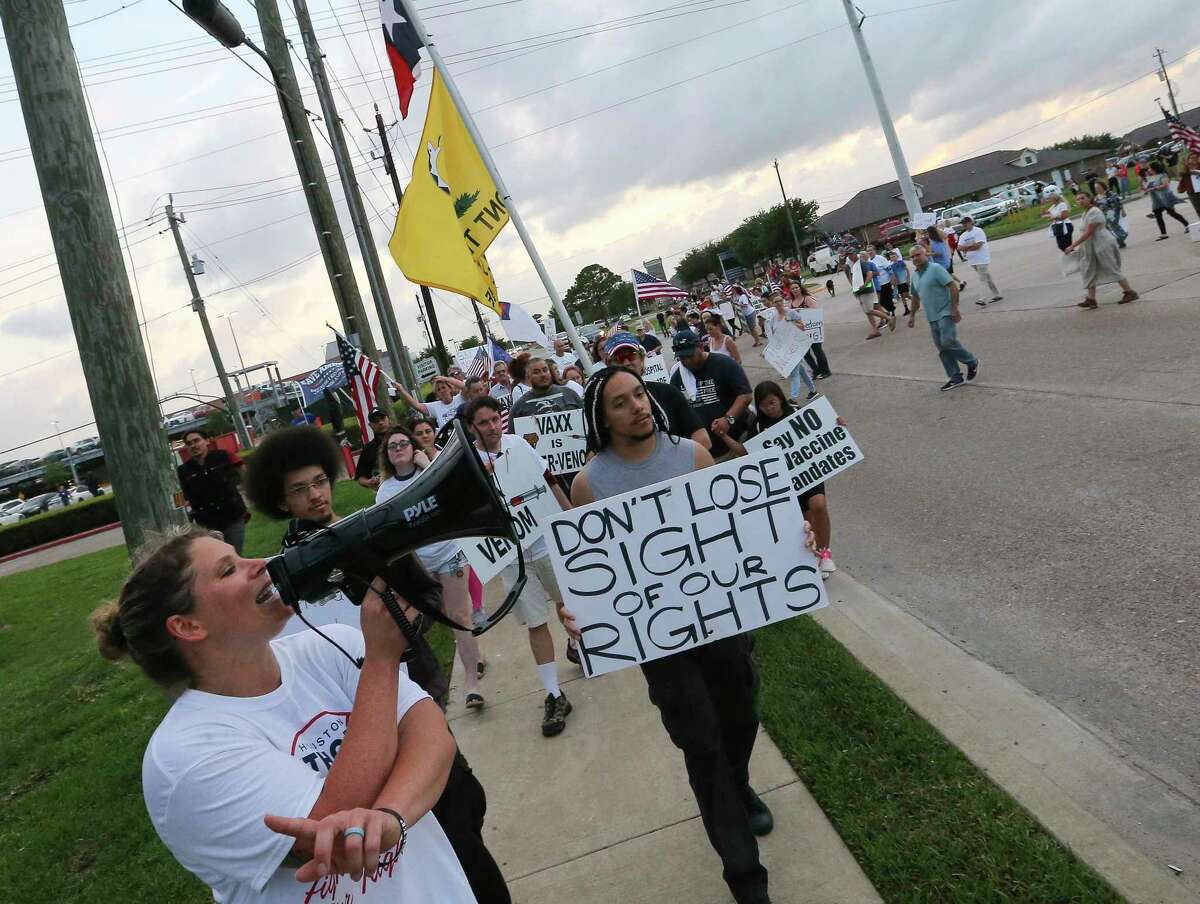 Protesters rally at Houston Methodist Baytown Hospital against the hospital system’s rule of firing any employee who is not immunized.
