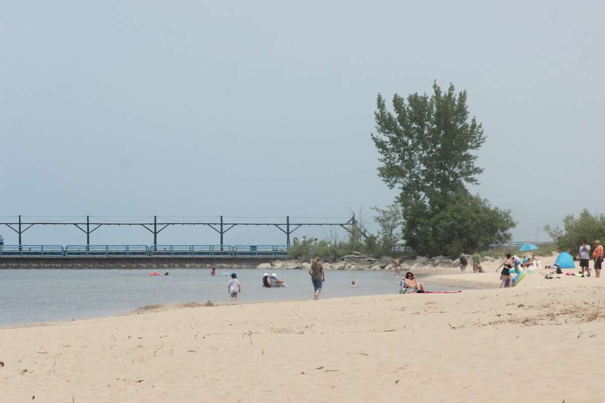 Beachgoers could be seen near the Manistee's First Street Beach pier where several children nearly drowned on May 25. Now efforts are under way to create a beach safety class for youth in Manistee. 