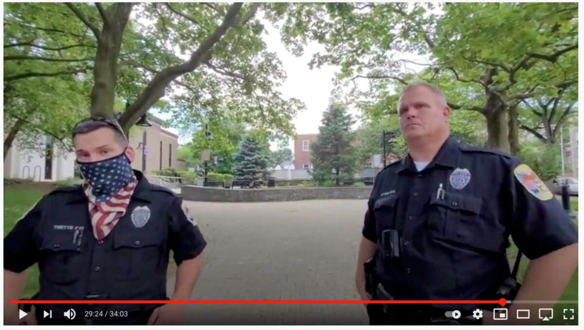 Danbury Police Chief Patrick Ridenhour announced an internal investigation into an incident he filmed at the Danbury Public Library. A screenshot from the video shows two of the officers who responded after a YouTuber filmed inside the library.
