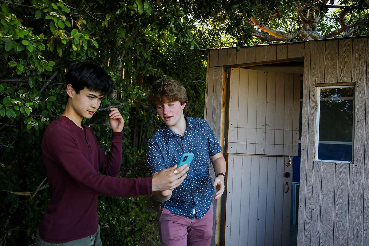 Friends Samson Stebbins (left), 16, and Steven Sutton, 15, create a TikTok video in San Mateo. According to online publication GayTimes, the popular social video app has “transformed into a place of education and self-discovery helping to reclaim the queer experience online.”