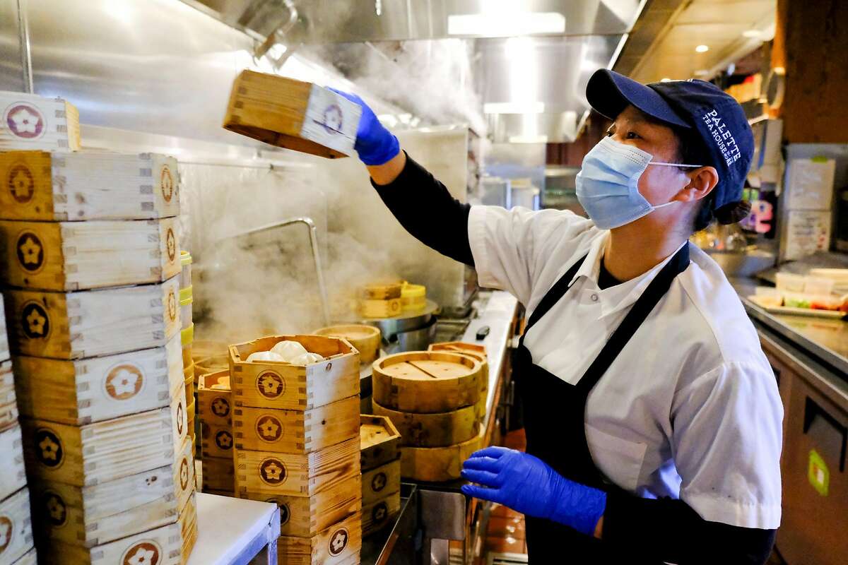 Line cook Lihua Guo operates the steamer at Palette Tea House in San Francisco.