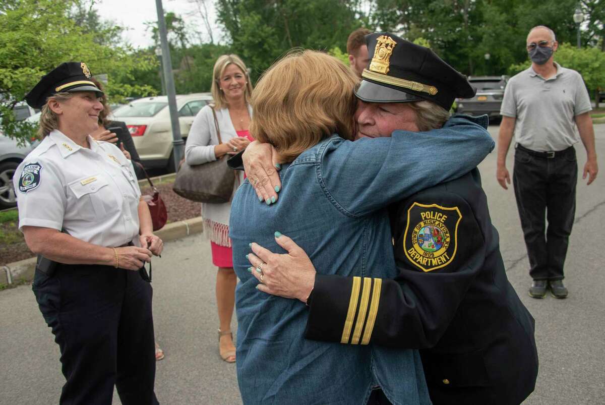 Outgoing Police Chief Frances Wall, right, gets a hug from Margaret Brennan as the Niskayuna Police Department honored her with a walk out ceremony outside the police department on Friday, June 11, 2021 in Niskayuna, N.Y. (Lori Van Buren/Times Union)