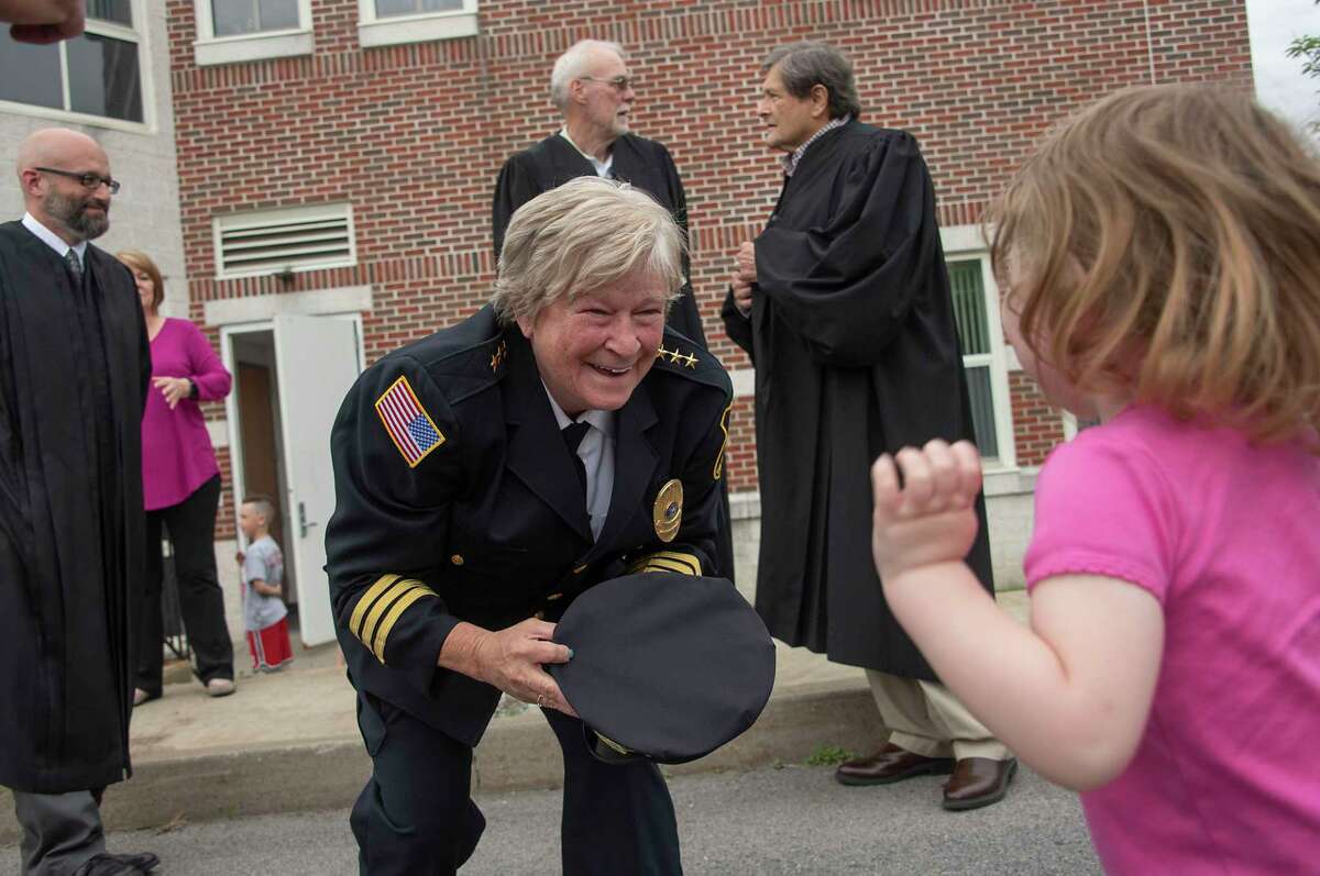 Outgoing Police Chief Frances Wall smiles at Taylor Kim, 2, before putting her chief hat on her as the Niskayuna Police Department honored her with a walk out ceremony outside the police department on Friday, June 11, 2021 in Niskayuna, N.Y. (Lori Van Buren/Times Union)