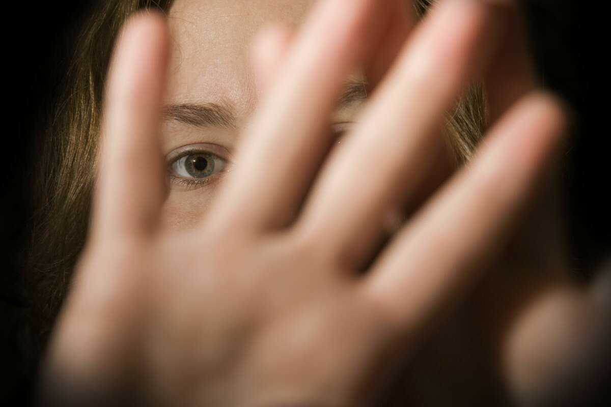 A woman's hands in front of her face.