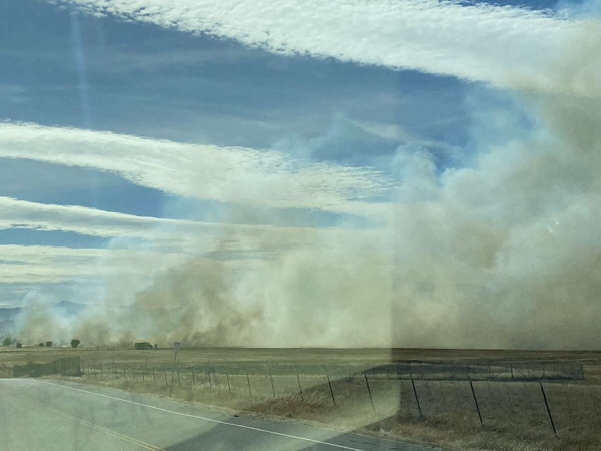 Firefighters were battling a three-alarm grass fire located off Markeley Lane in Fairfield on Friday afternoon, Fairfield Fire Department said.