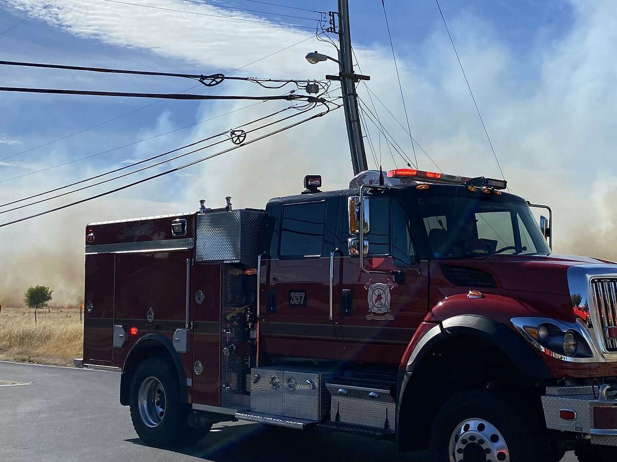 Firefighters were battling a three-alarm grass fire located off Markeley Lane in Fairfield on Friday afternoon, Fairfield Fire Department said.