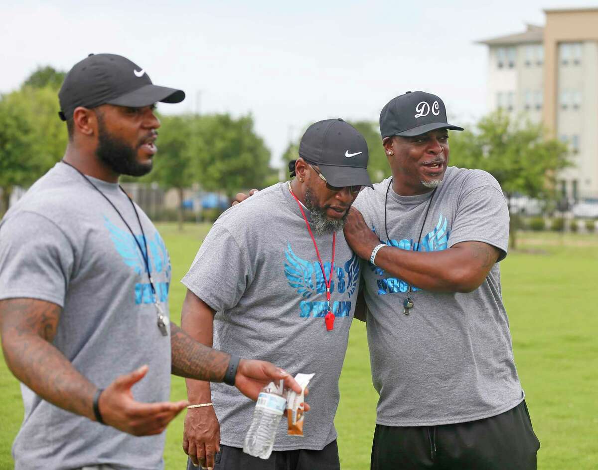 Dominic Cameron, right, jokes with fellow coaches Calvin Anderson, left, and Deese Golg. For the past 10 years, Cameron has hosted DC Speed Camp, a free 16-week program for youth and teens to work on athletic and agility skills at IDEA Harvey E. Najim charter school.