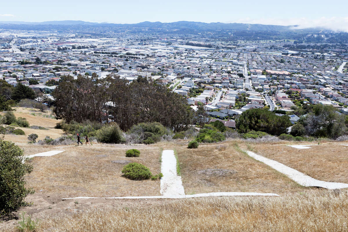 Hikers walk a 1.2-mile loop trail to the South San Francisco Sign on Sign Hill in South San Francisco, Calif., on June 12, 2021.